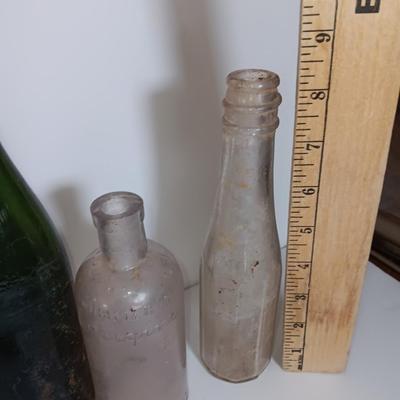 Antique glass bottles and two bottle openers