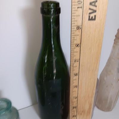 Antique glass bottles and two bottle openers