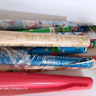 Several rolls of Christmas wrapping paper
