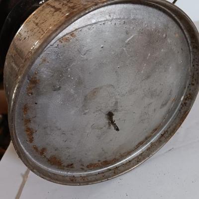 two vintage lanterns for repair with a metal container of camp fuel