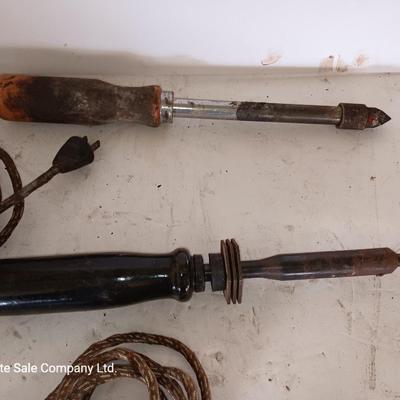 Two antique electric soldering irons with different sized heads