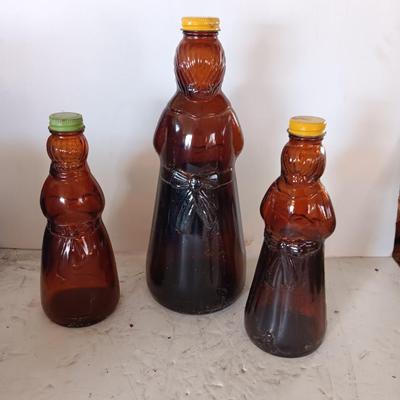 Three different sized Mrs. Butterworths bottles