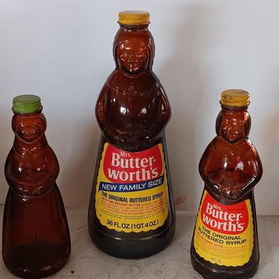 Three different sized Mrs. Butterworths bottles