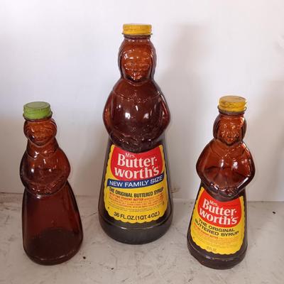 Three different sized Mrs. Butterworths bottles