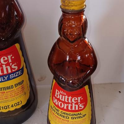 Three different sized Mrs. Butterworths bottles