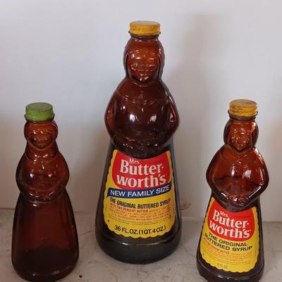 Three different sized Mrs. Butterworths bottles