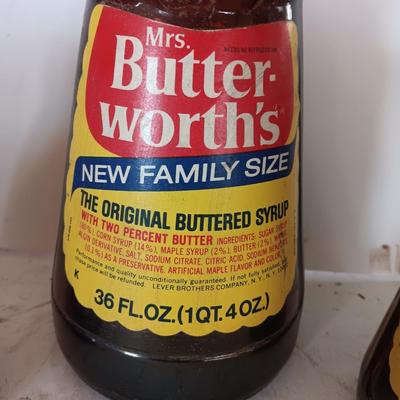 Three different sized Mrs. Butterworths bottles