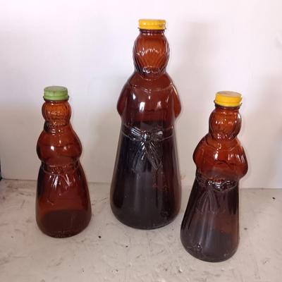 Three different sized Mrs. Butterworths bottles
