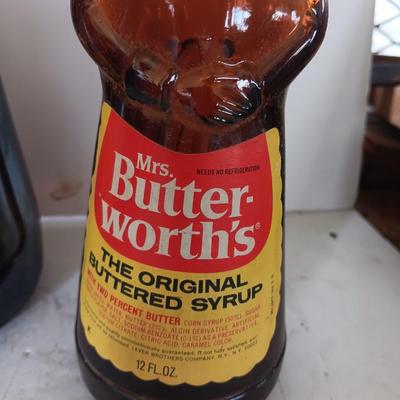 Three different sized Mrs. Butterworths bottles