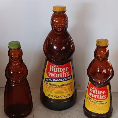 Three different sized Mrs. Butterworths bottles