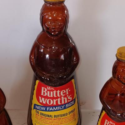 Three different sized Mrs. Butterworths bottles