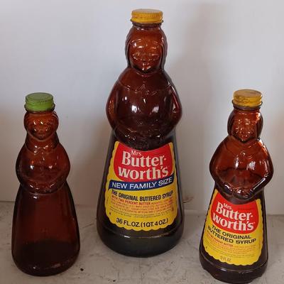 Three different sized Mrs. Butterworths bottles