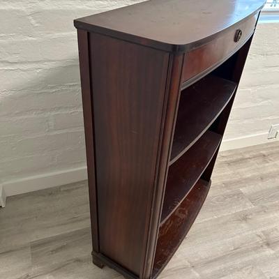 Vintage book stand with top shelf drawer.
