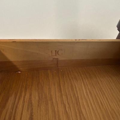 Vintage book stand with top shelf drawer.