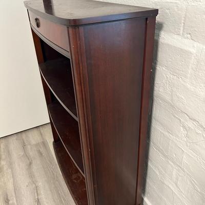 Vintage book stand with top shelf drawer.