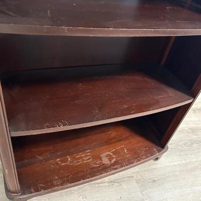 Vintage book stand with top shelf drawer.