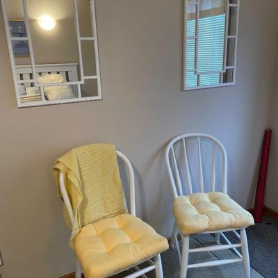 White chairs and mirror wall hangings