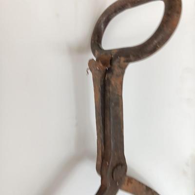 old antique iron tongs, primitive vintage farm icehouse block and steel ring with a handle
