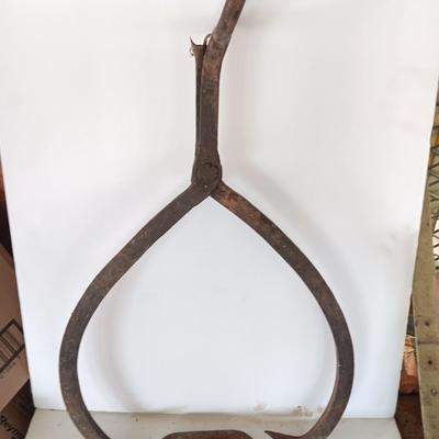 old antique iron tongs, primitive vintage farm icehouse block and steel ring with a handle