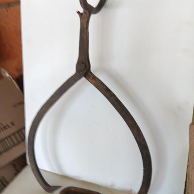 old antique iron tongs, primitive vintage farm icehouse block and steel ring with a handle