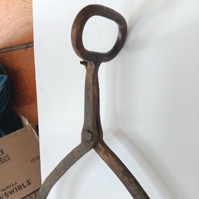 old antique iron tongs, primitive vintage farm icehouse block and steel ring with a handle