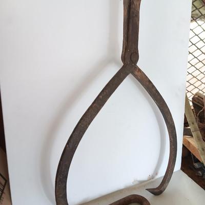 old antique iron tongs, primitive vintage farm icehouse block and steel ring with a handle