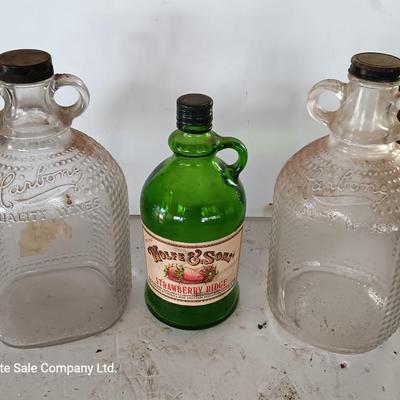 Three glass jugs with handles embossed glass design on two