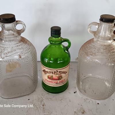 Three glass jugs with handles embossed glass design on two