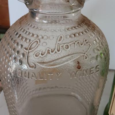 Three glass jugs with handles embossed glass design on two