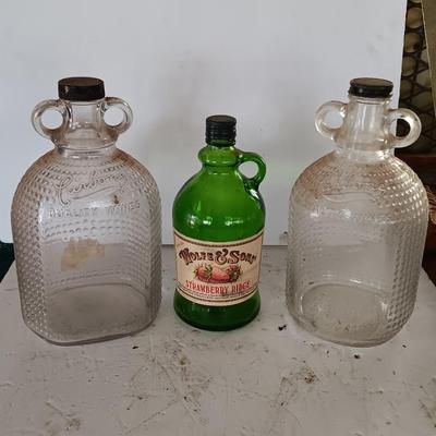 Three glass jugs with handles embossed glass design on two