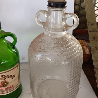 Three glass jugs with handles embossed glass design on two