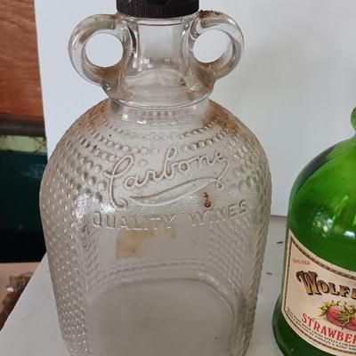 Three glass jugs with handles embossed glass design on two