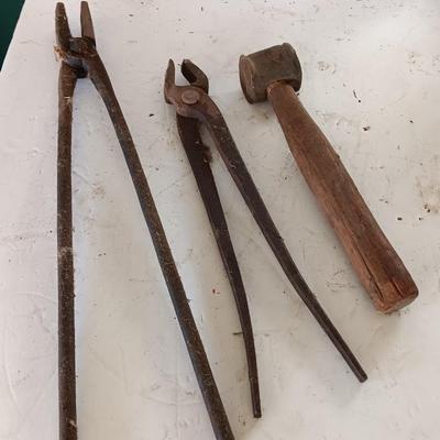 Blacksmith Blacksmithing tools Pliers, nips and hammer.