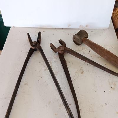 Blacksmith Blacksmithing tools Pliers, nips and hammer.