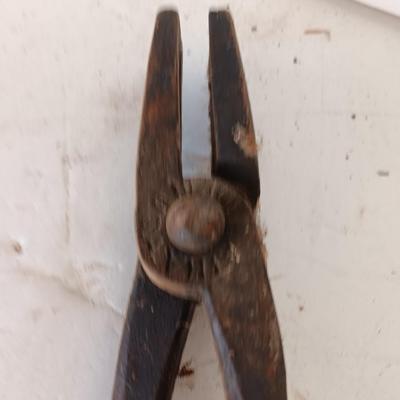 Blacksmith Blacksmithing tools Pliers, nips and hammer.