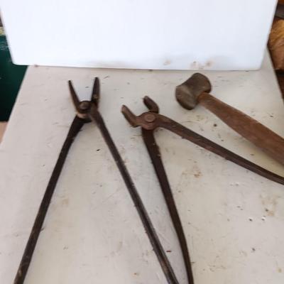 Blacksmith Blacksmithing tools Pliers, nips and hammer.