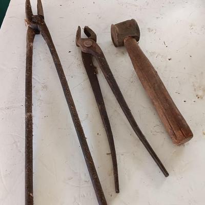 Blacksmith Blacksmithing tools Pliers, nips and hammer.