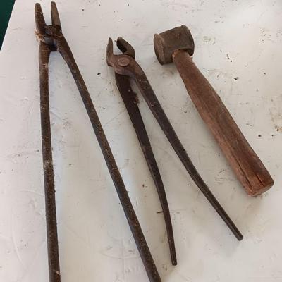 Blacksmith Blacksmithing tools Pliers, nips and hammer.