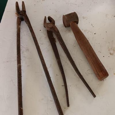Blacksmith Blacksmithing tools Pliers, nips and hammer.