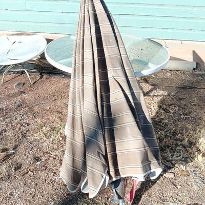 39" Round glass topped patio table with Plantation Pattern Umbrella.