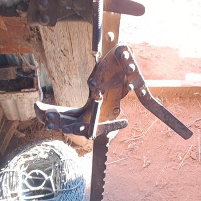 Fence stretcher tool with partial roll of barbed wire