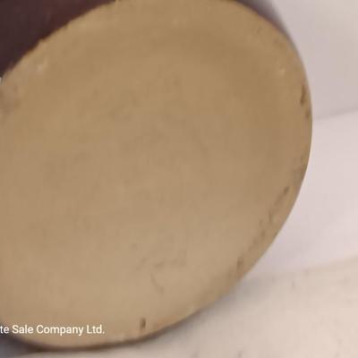 Four small brown crock bowls with embroidered linen