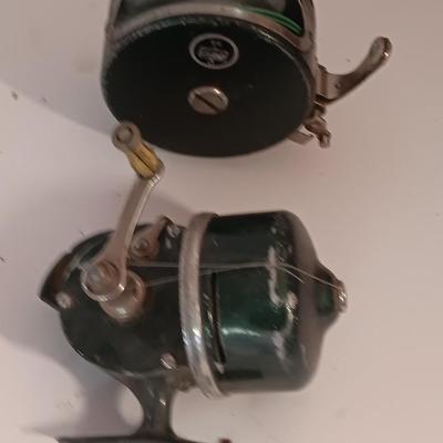 Two fishing reels Shakespeare push button Wondercast No. 1774 and green Fly fishing reel