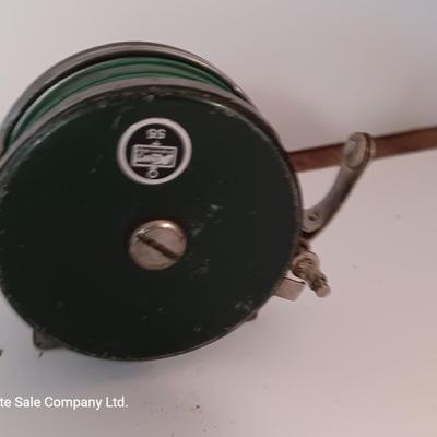 Two fishing reels Shakespeare push button Wondercast No. 1774 and green Fly fishing reel