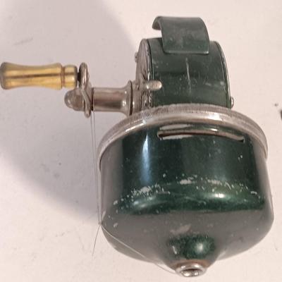 Two fishing reels Shakespeare push button Wondercast No. 1774 and green Fly fishing reel