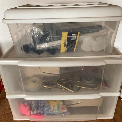 3 small storage containers with office items