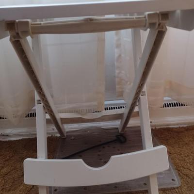 white plastic tv stand