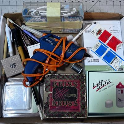 Crafting items: Stamp pad, Glue Gun and Paint Brushes. 