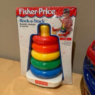Lot 272 huggy sport ring, toss game and Fisher-Price rock a stack toy
