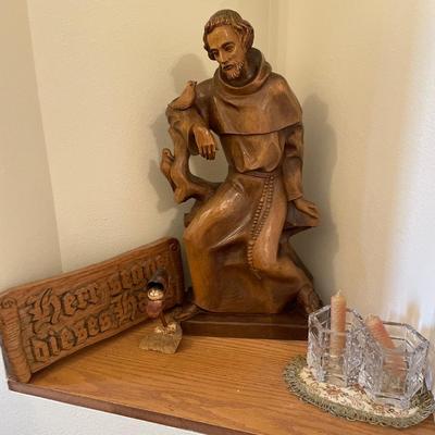Wood carved St. Francis and German sign with crystal candle holders